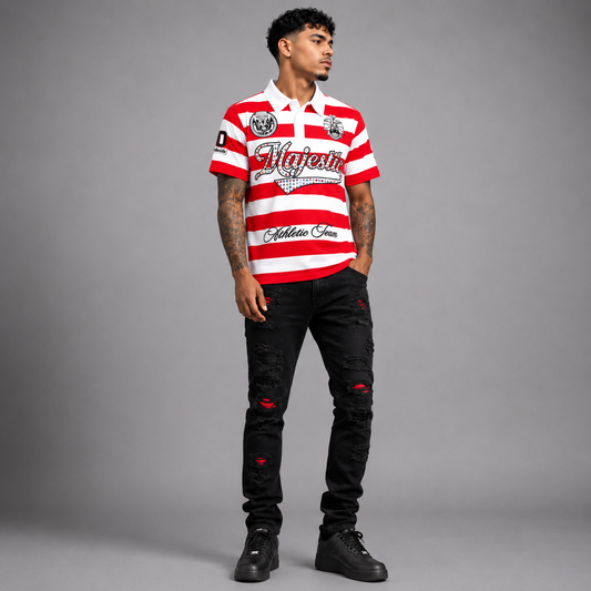 A man modeling a red and white horizontally striped short-sleeve polo shirt with 'Majestic' and 'Athletic Jeans' branding, paired with black distressed jeans and black sneakers, against a solid gray studio background.